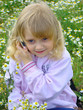 Photo: Little girl communicates by a mobile telephone. Little girl communicates by a mobile telephone.