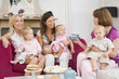 Photo: Three mothers in living room with babies and coffee smiling Three mothers in living room with babies and coffee smiling