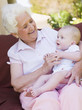 Grandmother outdoors on patio with baby smiling