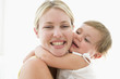 사진:Mother and baby indoors hugging and smiling Mother and baby indoors hugging and smiling