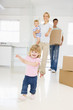 Photo: Family with box moving into new home smiling Family with box moving into new home smiling