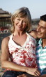 Photo: Mature adult couple sitting on beach Mature adult couple sitting on beach