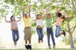 Photo: Five young friends jumping outdoors smiling Five young friends jumping outdoors smiling
