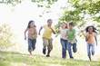 Photo: Five young friends running outdoors smiling Five young friends running outdoors smiling