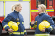 Two female firefighters by a fire engine