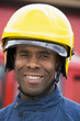 Portrait of a firefighter standing in front of a fire engine