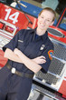 Portrait of a firefighter by a fire engine