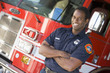 Portrait of a firefighter by a fire engine