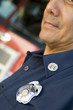 Portrait of a firefighter by a fire engine