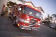 Fire engine rushing out of a fire station