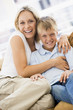 Woman and young boy sitting in living room smiling