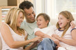 Family Sitting In Living Room ...