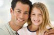 Man and young girl in living room smiling