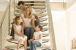 Family sitting on staircase smiling