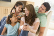 Photo: Family sitting in living room smiling Family sitting in living room smiling