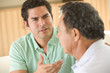 Photo: Two men in living room arguing Two men in living room arguing