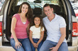 Photo: Family sitting in back of van smiling Family sitting in back of van smiling