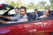 Foto: Family in convertible car smiling Family in convertible car smiling