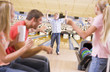 Foto: Family in bowling alley cheering and smiling Family in bowling alley cheering and smiling