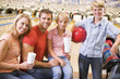 Foto: Family in bowling alley with drinks smiling Family in bowling alley with drinks smiling