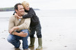 Father and son at beach smiling