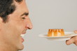 Young male adult being offered a dessert