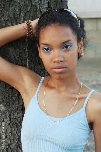 Photo: A beautiful attractive African girl outdoors in sunshine A beautiful attractive African girl outdoors in sunshine