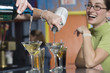 View of a young woman laughing at the bar counter.