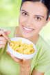 young woman eating cornflakes