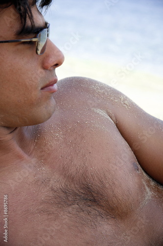 Photo: Closeup of young man on beach Closeup of young man on beach