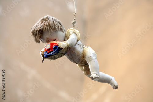 Photo: Old doll holding Viewmaster hanging in the air Old doll holding Viewmaster hanging in the air