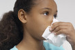 Girl 7-9 blowing nose, close-up