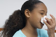 Girl 7-9 blowing nose, close-up