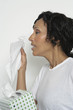Woman holding box of tissues, studio shot