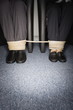 Male and female business people's legs tied