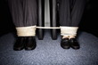 Male and female business people's legs tied