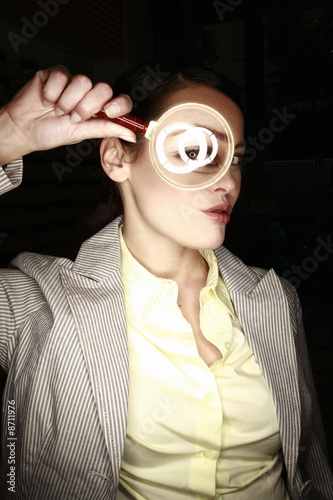 Photo: Woman with magnifying glass on eye Woman with magnifying glass on eye