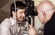 Optometrist examining patient