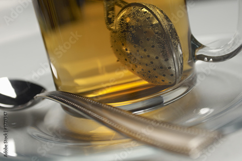 Photo: Glass with tea strainer inside, close-up Glass with tea strainer inside, close-up