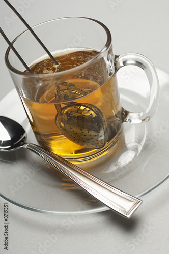Photo: Glass with tea strainer inside, close-up Glass with tea strainer inside, close-up