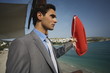 Businessman on life guard stand with life preserver