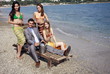 Businessman on beach with three women