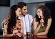 Two women and man in a bar