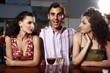 Two women and man in a bar