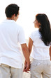 Couple Holding Hands at the Beach Looking at each other Couple Holding Hands at the Beach Looking at each other