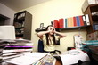 Female office worker at cluttered desk