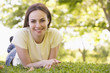 Woman lying outdoors smiling
