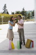 Couple with shopping bags;man offering roses