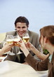 Office workers toasting with beer in outdoor cafe