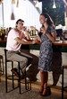 Couple in a bar;man smoking cigar